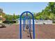 Blue metal swings hang in a well-kept community playground near the pool at 5340 Riva Ridge Dr, Wesley Chapel, FL 33544