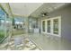 Enclosed sunroom with tile floors, a ceiling fan, and large windows offering plenty of natural light at 5340 Riva Ridge Dr, Wesley Chapel, FL 33544