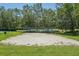 Outdoor sand volleyball court with a sturdy net and surrounded by green grass at 5340 Riva Ridge Dr, Wesley Chapel, FL 33544