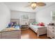 Bright bedroom featuring two beds, wood floors, and a ceiling fan at 5542 19Th N Ave, St Petersburg, FL 33710