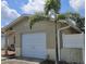 Side view of the house showing the one-car garage and a small palm tree at 5542 19Th N Ave, St Petersburg, FL 33710