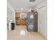 Functional kitchen featuring wood cabinets, stainless steel appliances, and tiled flooring at 5542 19Th N Ave, St Petersburg, FL 33710