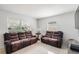 Inviting living room with comfortable leather seating and bright natural light from large windows at 5542 19Th N Ave, St Petersburg, FL 33710