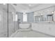 Bright bathroom with freestanding tub, walk-in shower, and elegant fixtures create a spa-like retreat at 555 5Th Ne Ave # 1032, St Petersburg, FL 33701