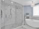 Luxurious bathroom boasts walk-in shower, a modern tub, stylish lighting, and serene color palette at 555 5Th Ne Ave # 1032, St Petersburg, FL 33701