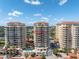 Exterior view of modern condominiums, highlighting a central pool, balconies, and a private entry road at 555 5Th Ne Ave # 1032, St Petersburg, FL 33701