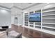 Spacious living room boasts custom built-ins, wood flooring, and a neutral color palette for a peaceful ambiance at 555 5Th Ne Ave # 1032, St Petersburg, FL 33701
