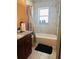 Bathroom showcasing a shower-tub combo, marble tile and vanity at 5805 Tennessee Ave, New Port Richey, FL 34652