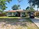 Charming single-story home with a well-maintained yard and convenient golf cart parking at 5805 Tennessee Ave, New Port Richey, FL 34652