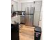 Well-lit kitchen featuring stainless steel appliances, gray cabinets and modern fixtures at 5805 Tennessee Ave, New Port Richey, FL 34652