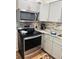 Modern kitchen with stainless steel appliances and gray cabinetry at 5805 Tennessee Ave, New Port Richey, FL 34652
