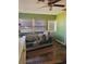 A comfortable living room with warm wood floors and lots of sunlight coming through the windows at 5805 Tennessee Ave, New Port Richey, FL 34652