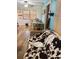 Cozy living room featuring wood floors, lots of light and comfortable seating with a cow print blanket at 5805 Tennessee Ave, New Port Richey, FL 34652