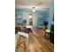 Inviting living room with light blue walls, wood floors and bright, airy atmosphere at 5805 Tennessee Ave, New Port Richey, FL 34652