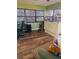 Well-lit living room featuring office space and home gym equipment at 5805 Tennessee Ave, New Port Richey, FL 34652