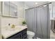 Neutral bathroom featuring updated hardware, and a shower with gray curtain at 6149 37Th N Ave, St Petersburg, FL 33710