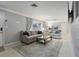 Comfortable living room is furnished with a sofa, loveseat, rug, and television with neutral walls and stylish decor at 6149 37Th N Ave, St Petersburg, FL 33710