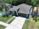 Impressive aerial view showcasing a home with a spacious driveway and pristine landscaping in a Gathering-friendly neighborhood at 6205 Chapel Pines Blvd, Wesley Chapel, FL 33545