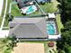 Beautiful aerial showcasing a screened pool and lanai, lush landscaping, and a spacious backyard, creating a private oasis at 6205 Chapel Pines Blvd, Wesley Chapel, FL 33545