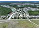 Aerial view displays home's location in residential community with mature trees, waterways, and access to nearby amenities at 6205 Chapel Pines Blvd, Wesley Chapel, FL 33545