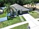Stunning aerial view of a well-maintained home with a lush green lawn and a long driveway in a serene setting at 6205 Chapel Pines Blvd, Wesley Chapel, FL 33545