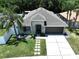 Beautiful aerial view of the single-story home with a well manicured lawn and a long driveway in a serene setting at 6205 Chapel Pines Blvd, Wesley Chapel, FL 33545