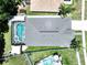 Overhead aerial shot showcases backyard swimming pool and spa, patio, and green backyard, highlighting outdoor living at 6205 Chapel Pines Blvd, Wesley Chapel, FL 33545