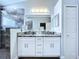 Updated bathroom featuring double sinks, granite countertops, and modern finishes at 6205 Chapel Pines Blvd, Wesley Chapel, FL 33545