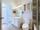 Bright bathroom showcasing a vanity with ample storage and glass doored cabinet at 6205 Chapel Pines Blvd, Wesley Chapel, FL 33545