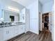 This bathroom features double sinks and a closet leading to the bedroom at 6205 Chapel Pines Blvd, Wesley Chapel, FL 33545