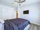 Modern bedroom with wood-look floors, closet, and ceiling fan for comfort at 6205 Chapel Pines Blvd, Wesley Chapel, FL 33545