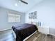 Bedroom with wood-look floors, modern ceiling fan, and vaulted ceiling provides a relaxing space at 6205 Chapel Pines Blvd, Wesley Chapel, FL 33545