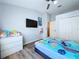 Bedroom with wood-look floors, closet, and ceiling fan offers a comfortable retreat at 6205 Chapel Pines Blvd, Wesley Chapel, FL 33545