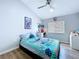 Bedroom with wood-look floors, ceiling fan, and modern accents provides a stylish space at 6205 Chapel Pines Blvd, Wesley Chapel, FL 33545