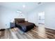 This bedroom offers wood floors and a door leading into the primary bath at 6205 Chapel Pines Blvd, Wesley Chapel, FL 33545