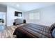 The spacious bedroom has wood floors, modern TV, and a dresser for storage at 6205 Chapel Pines Blvd, Wesley Chapel, FL 33545