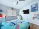 Bedroom with wood-look floors, ceiling fan, and desk provides a functional and stylish space at 6205 Chapel Pines Blvd, Wesley Chapel, FL 33545