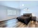 Light and airy bedroom with wood floors, neutral walls, and a large window for natural light at 6205 Chapel Pines Blvd, Wesley Chapel, FL 33545