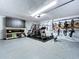 Spacious garage with epoxy floors, home gym, and ample storage space at 6205 Chapel Pines Blvd, Wesley Chapel, FL 33545