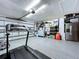 Spacious garage with ample storage, epoxy floor, and side-by-side refrigerator at 6205 Chapel Pines Blvd, Wesley Chapel, FL 33545
