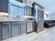 Updated kitchen featuring stainless steel appliances, gray cabinetry, and modern backsplash at 6205 Chapel Pines Blvd, Wesley Chapel, FL 33545