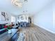 Bright living room showcases wood floors, decorative lighting, and an elegant dining area at 6205 Chapel Pines Blvd, Wesley Chapel, FL 33545