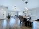 Spacious living area that flows to dining area featuring contemporary décor and natural light at 6205 Chapel Pines Blvd, Wesley Chapel, FL 33545