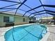 Beautiful pool with spa inside a screened enclosure, offering privacy and protection from the elements at 6205 Chapel Pines Blvd, Wesley Chapel, FL 33545