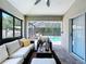 Inviting sunroom with cushioned seating and views of the pool and outdoor space at 6205 Chapel Pines Blvd, Wesley Chapel, FL 33545