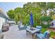 Inviting backyard patio with outdoor seating, a grill, and a view of the lush tropical landscaping at 6232 Crickethollow Dr, Riverview, FL 33578