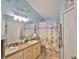 Bright bathroom with double sinks, ample lighting, and beach themed decor at 6232 Crickethollow Dr, Riverview, FL 33578