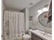 Cozy bathroom featuring neutral tones, shower with curtain, mirrored vanity, and decorative artwork at 6232 Crickethollow Dr, Riverview, FL 33578