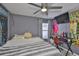 Comfortable bedroom with hardwood floors, ceiling fan, window with blinds, and cool decorations at 6232 Crickethollow Dr, Riverview, FL 33578