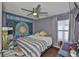 Comfortable bedroom with hardwood floors, ceiling fan, window with blinds, and cool decorations at 6232 Crickethollow Dr, Riverview, FL 33578